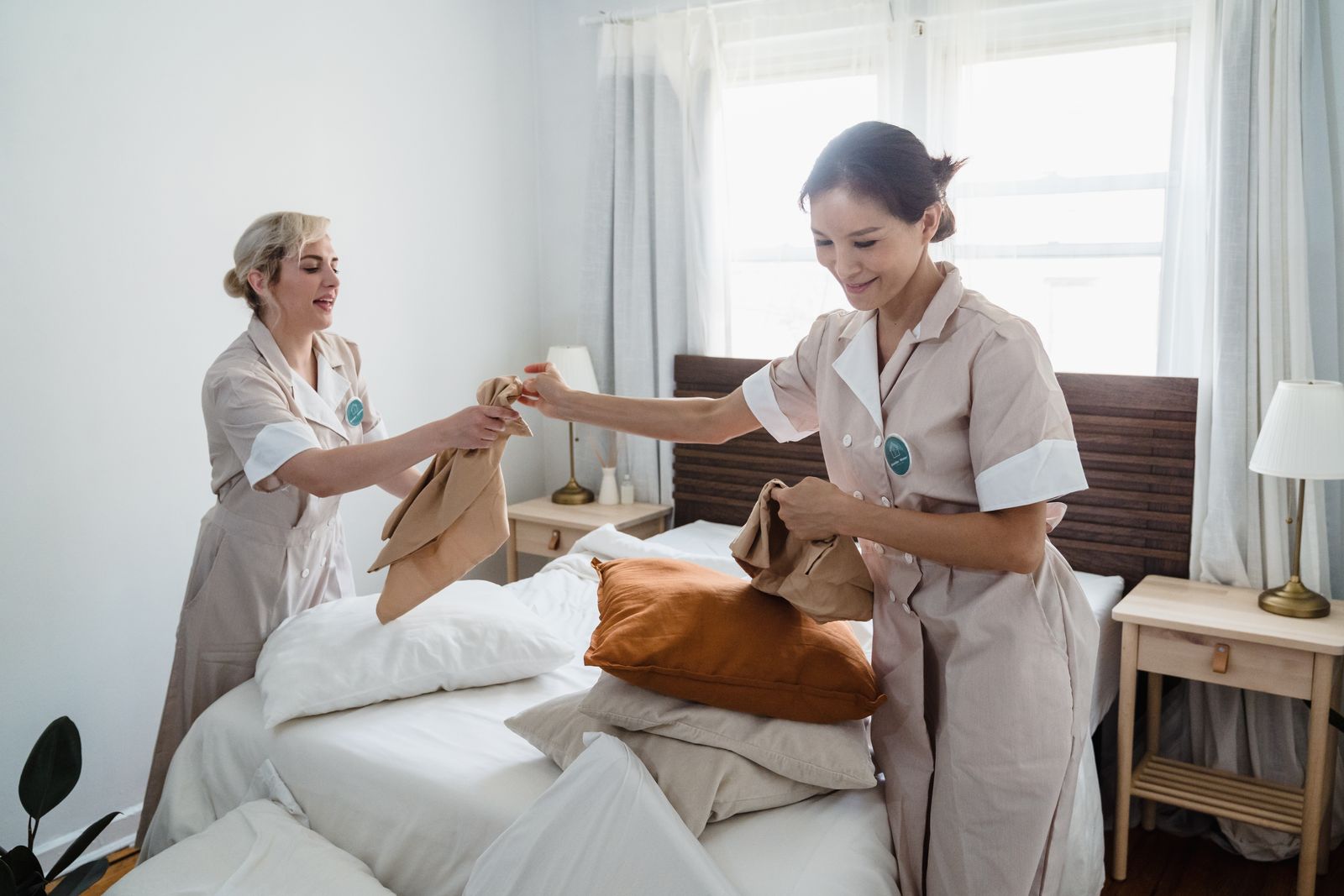 Two Brightwell housekeepers making a bed together